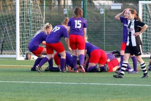 Wymondham Town Ladies congratulating each other on their semi-final cup win