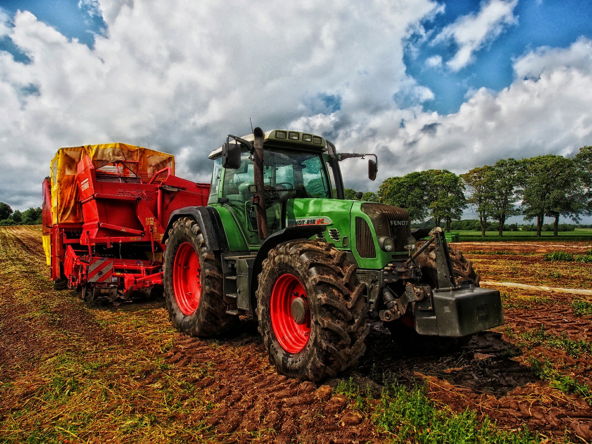 Tractor in a field showing farmer harvesting